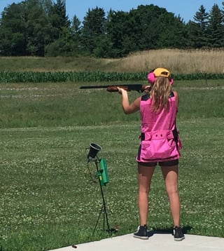 Jenna practicing shooting a shotgun.